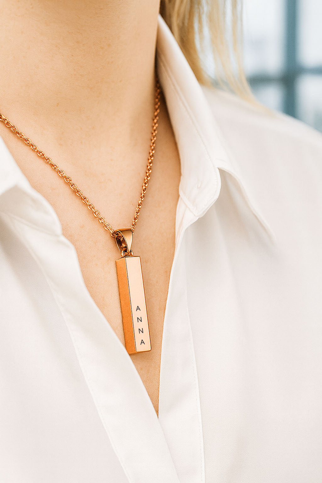 Girl wears 3d bar pendant